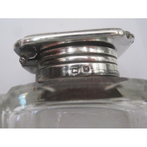 335 - A pair of silver mounted glass inkwells. The silver mounts bear the standard mark and date letter W