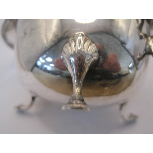 133 - Georgian style silver gravy boat with beaded rim, double scroll handle, on three hoof feet, partiall... 