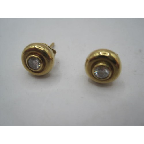 327 - Pair of 18 carat gold diamond stud earrings, the round studs diameter each about 7.5mm and set with ... 