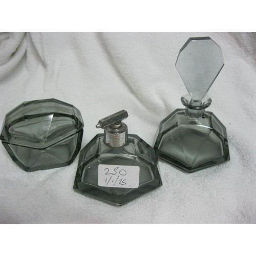 250 - A smokey grey art deco scent bottle, lidded pot and matching atomiser, the atomiser requires a new r... 