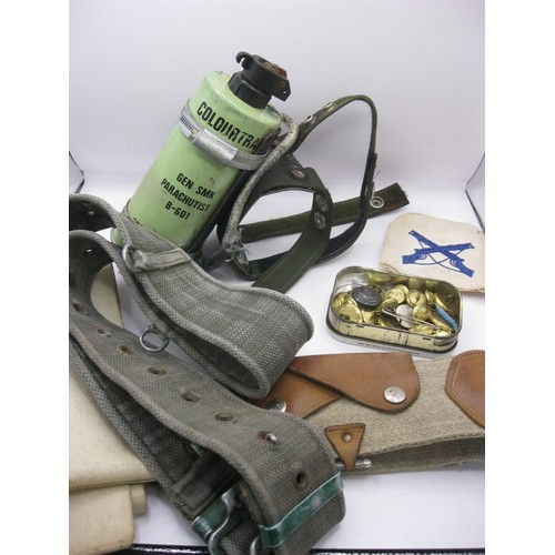 27 - A basket of military items including a various belts, a vintage St Bruno tin of brass naval buttons,... 