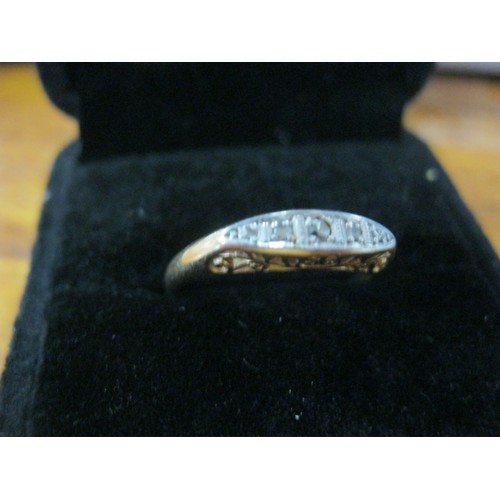 131 - An 18 carat gold ring set with 5 diamonds in a platinum mount, ring size R, approx weight 2.7g