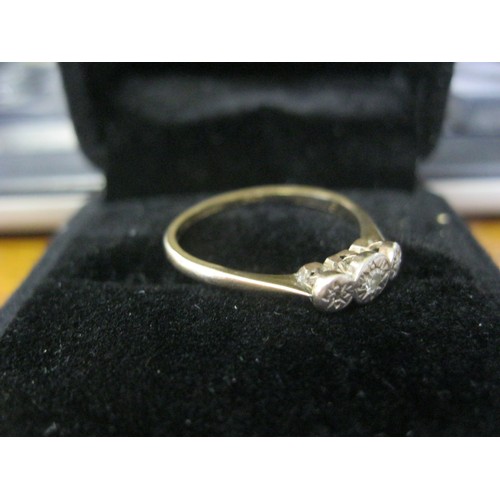 132 - A 9 carat gold ring set with 3 diamonds in a palladium mount, ring size N/O, approx weight 1.4g