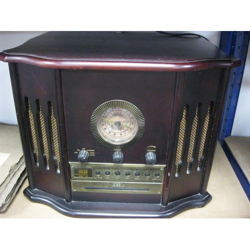 64 - A vintage style Music Centre, comprising a Record Player, Radio and Cassette Player in a dark wood c... 