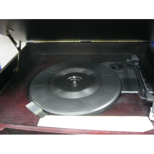 64 - A vintage style Music Centre, comprising a Record Player, Radio and Cassette Player in a dark wood c... 