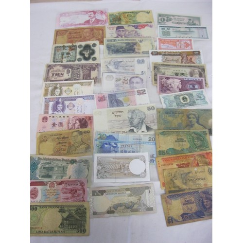 54 - 33 banknotes from a wide assortment of Asian nations including China, Singapore, Indonesia, Afghanis... 