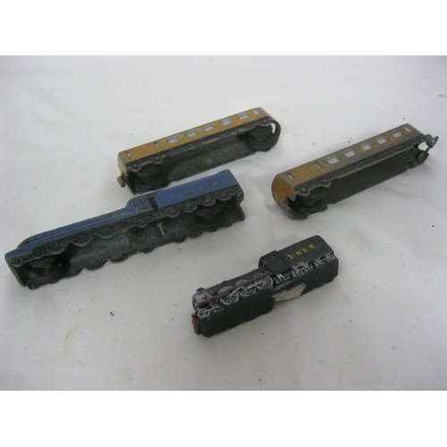 278 - A Dinky Toys 'Mallard' railway engine and two matching coaches, plus another small engine, all a/f