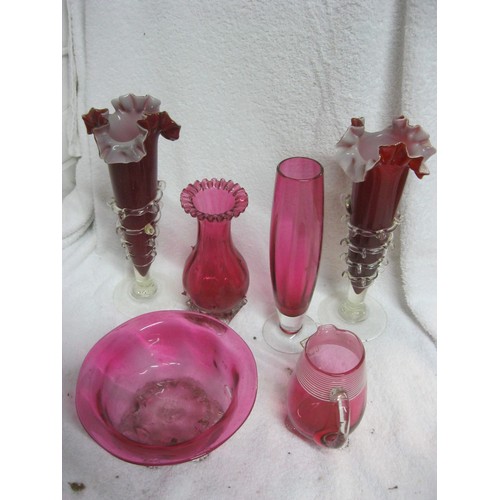 402 - An assortment of cranberry glass items, several of some age