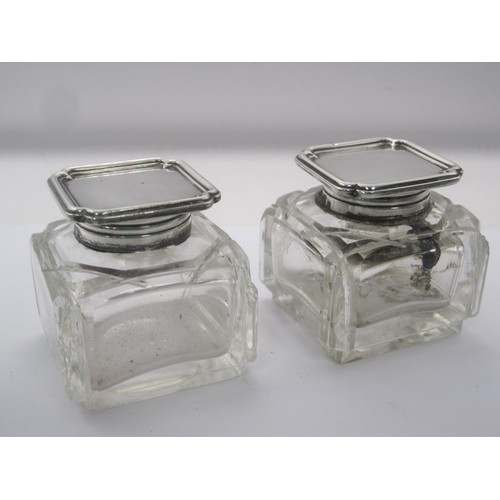 225 - A pair of silver mounted glass inkwells. The silver mounts bear the standard mark and date letter W