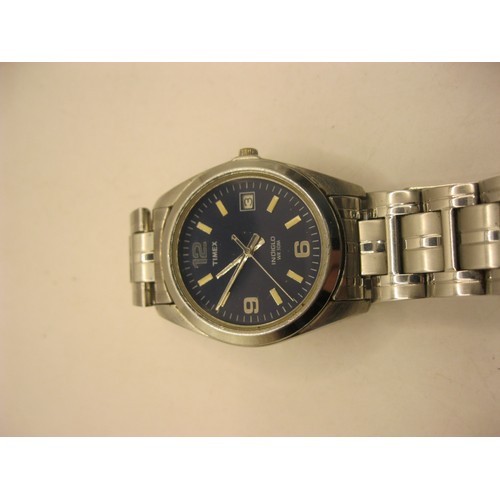 95 - Three gents quartz wristwatches - a Timex Indiglo stainless steel with baton and Arabic numerals and... 