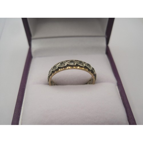 91 - A yellow metal eternity style ring set with white stones, indistinct stamped mark, ring size O, gros... 