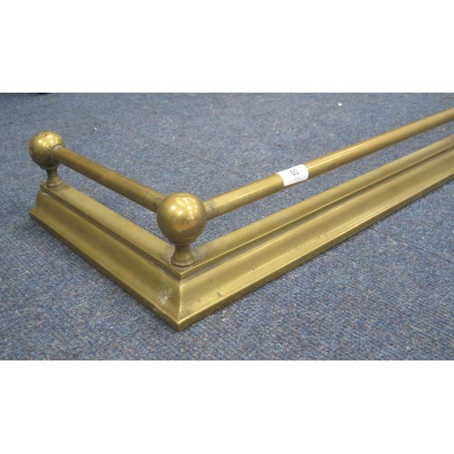 60 - A brass fender with tube and ball rail. Width 125cm, depth 30cm