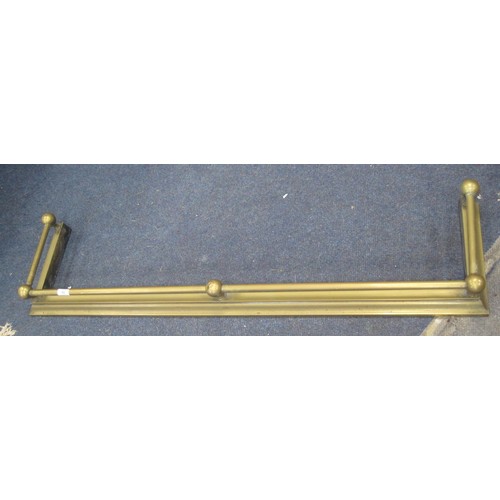 60 - A brass fender with tube and ball rail. Width 125cm, depth 30cm