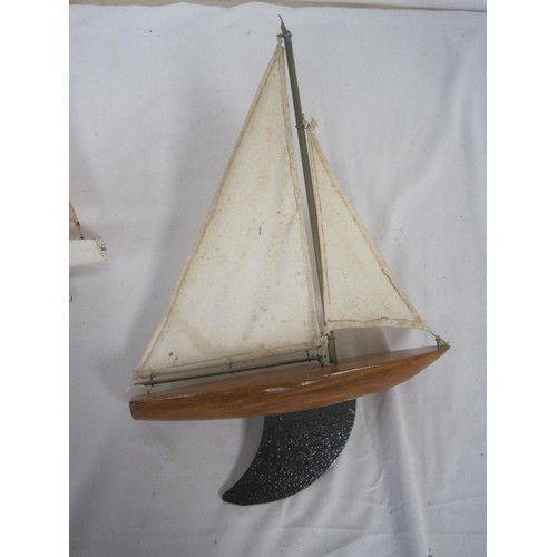 113 - Three model pond yachts (the smallest is a Skipper 6), each with solid wooden hulls and metal keels.... 