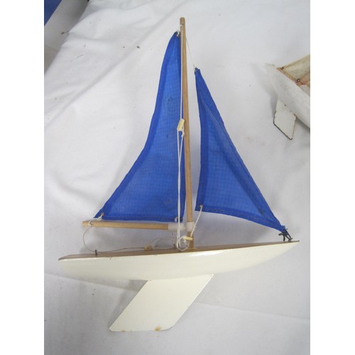 113 - Three model pond yachts (the smallest is a Skipper 6), each with solid wooden hulls and metal keels.... 