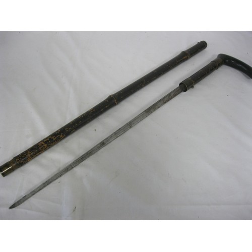 100 - A bamboo shafted sword stick with a 46cms triangular blade, with an overall length of 81cms.