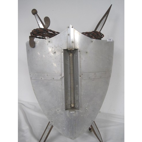 114 - A vintage room heater formed as a shield with crossed swords, with a single vertical heating element... 