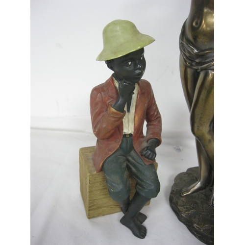 203 - A bronzed effect statue of a pair of lovers and a chalkware figure of a black man