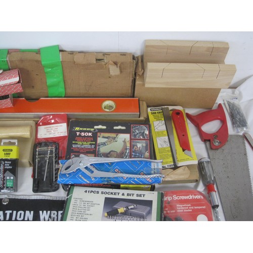 106 - A large box of tools to include a level, various saws, socket  set, new hammer, new chisels and many... 