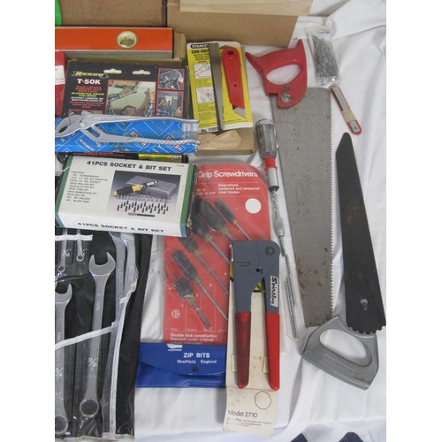 106 - A large box of tools to include a level, various saws, socket  set, new hammer, new chisels and many... 