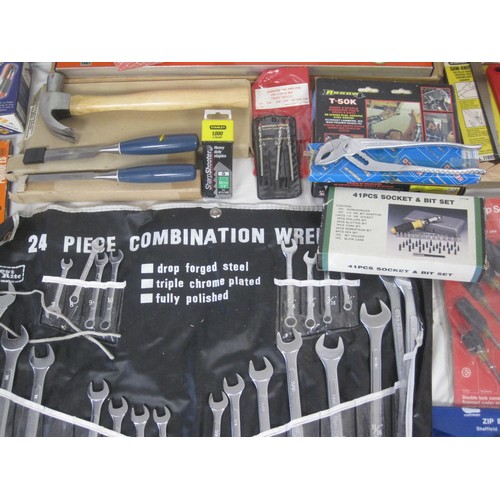 106 - A large box of tools to include a level, various saws, socket  set, new hammer, new chisels and many... 