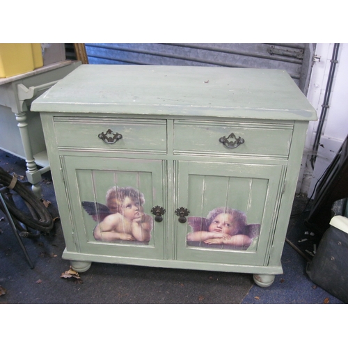 22 - An antique drawer and cupboard unit, shabby chic finish - painted green with applied murals to doors... 