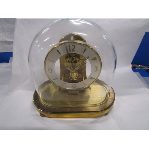 21 - A Kundo domed clock which works on an electrical pendulum action .
Dome is in pristine condition and... 