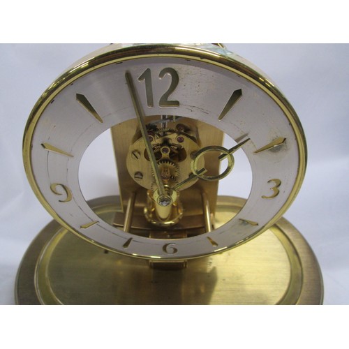 21 - A Kundo domed clock which works on an electrical pendulum action .
Dome is in pristine condition and... 