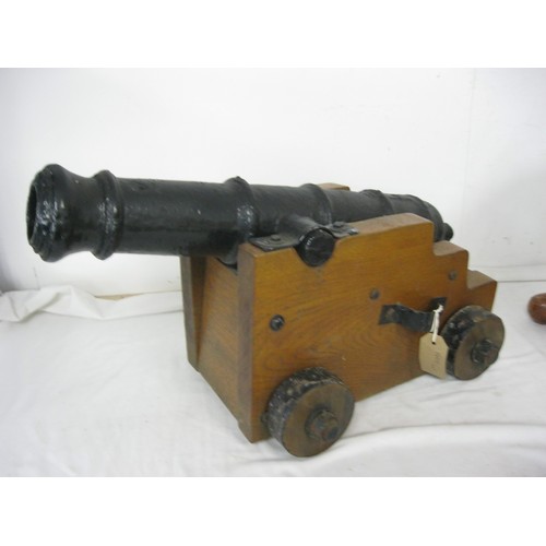 60 - An ornamental garden cannon with a 59cms barrel mounted on a wooden carriage with tin rimmed wooden ... 