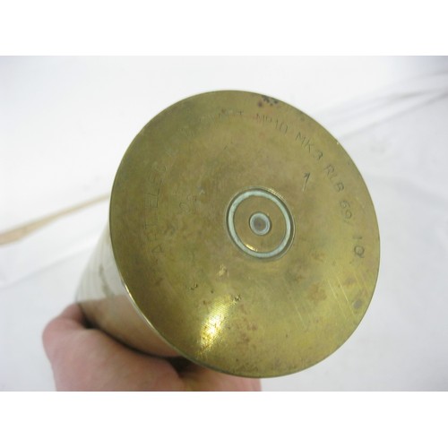 68 - (475) A brass shell case with a wooden dummy artillery shell. Overall height 34cms by 8cms diameter ... 