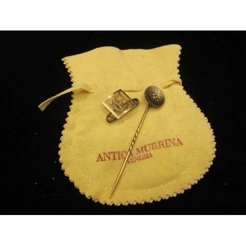 47 - A stick pin set with three diamonds, and a yellow metal initial G brooch. (1) A lapel or hat pin, ta... 