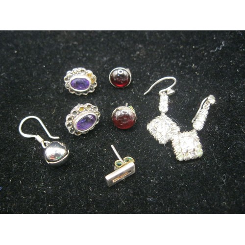 49 - Three pairs of vintage earrings. (1) set with red cabouchon, marked 925 SIL. (2) purple stone and ma... 