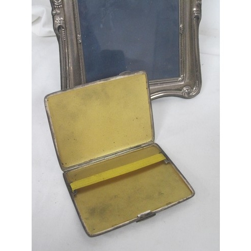 55 - An electroplated engine turned cigarette case, and a silver-plated photograph frame, about 25cm x 18... 