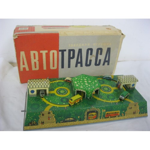 3 - A boxed Soviet-era Russian clockwork toy featuring trucks and buses circling their garages, in worki... 