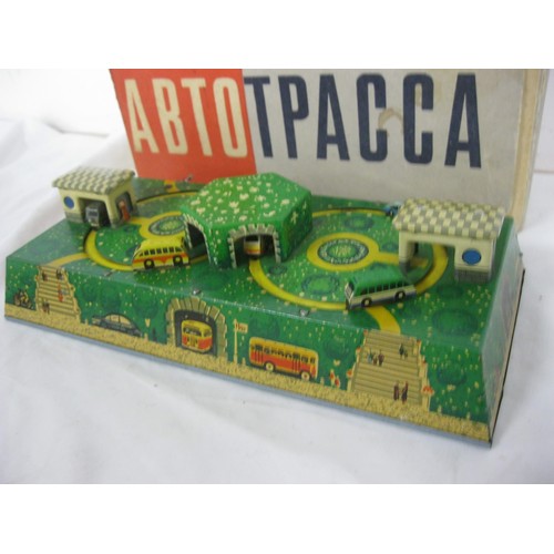 3 - A boxed Soviet-era Russian clockwork toy featuring trucks and buses circling their garages, in worki... 