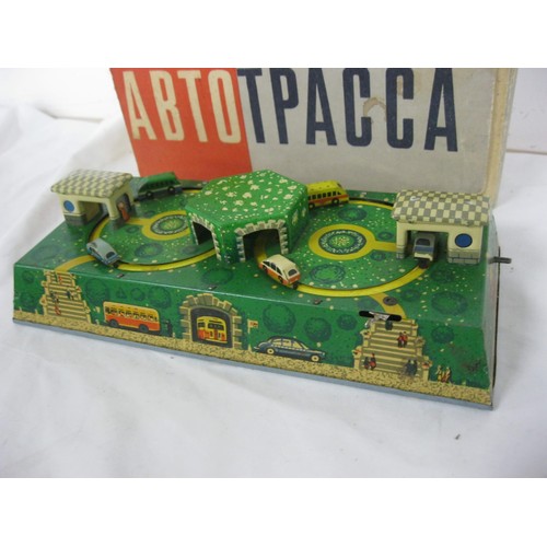 3 - A boxed Soviet-era Russian clockwork toy featuring trucks and buses circling their garages, in worki... 