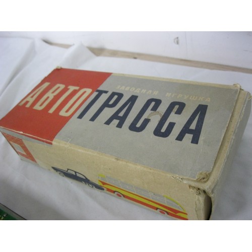 3 - A boxed Soviet-era Russian clockwork toy featuring trucks and buses circling their garages, in worki... 