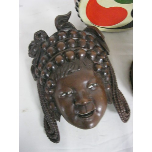 33 - An Far eastern maybe Indonesian Mask of a Goddess in a rich dark wood along with an African monkey t... 