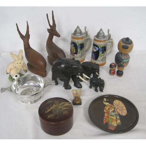 37 - A mixed lot consisting of carved wooden animals, German steins, Japanese items including a coaster s... 