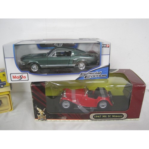 65 - A selection of 1.18 diecast cars two boxed three unboxed in fair condition along with three other di... 