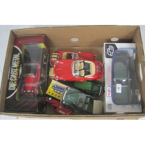 65 - A selection of 1.18 diecast cars two boxed three unboxed in fair condition along with three other di... 