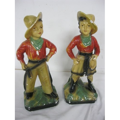 125 - A pair of vintage chalkware figures of a cowboy and a cowgirl, likely 1920s carnival prizes