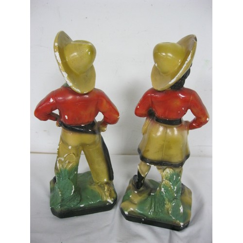 125 - A pair of vintage chalkware figures of a cowboy and a cowgirl, likely 1920s carnival prizes