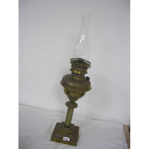 132 - A large and heavy vintage oil lamp with glass funnel on a square, stepped base, in good order