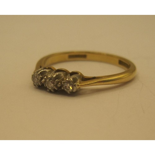 29 - An 18 carat gold three-stone diamond ring, size O/P, gross weight of ring 2.9g, stamped Bravingtons ... 