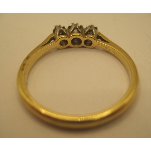 29 - An 18 carat gold three-stone diamond ring, size O/P, gross weight of ring 2.9g, stamped Bravingtons ... 