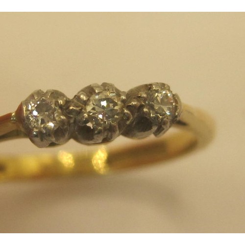 29 - An 18 carat gold three-stone diamond ring, size O/P, gross weight of ring 2.9g, stamped Bravingtons ... 