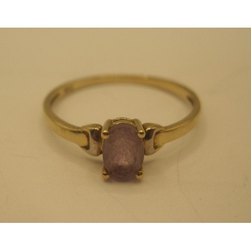 30 - A 9 carat gold ring set with an oval cut amethyst, ring size O, gross weight of ring approx. 0.9g, s... 