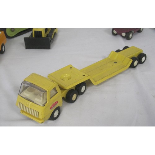 42 - A selection of Tonka toy model trucks including a smaller scale Articulated low loader all as per pi... 