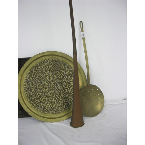 27 - A brass skimming pan, an embossed brass tray (diameter 46cm), and a decorative a/f copper post horn ... 